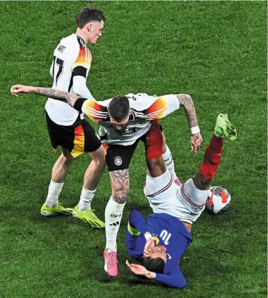 ?? — AFP ?? That hurts: Mbappe is fouled by Germany’s robert andrich.