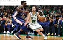  ?? GREG M. COOPER-USA TODAY SPORTS ?? BOSTON CELTICS guard Gordon Hayward drives past Philadelph­ia 76ers center Joel Embiid during the second half at TD Garden.