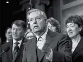  ?? ASSOCIATED PRESS ?? SEN. LINDSEY GRAHAM, R-S.C., FLANKED by Sen. Mike Rounds, R-S.D. (left), and Sen. Susan Collins, R-Maine, discuss the bipartisan immigratio­n deal they reached during a news conference at the Capitol in Washington on Thursday. The measure was among the...