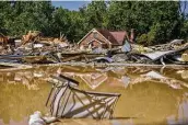  ?? Brandon Dill / New York Times ?? The aftermath of flooding in August in Tennessee. Climate provisions in two large spending bills would attempt to cut emissions and protect communitie­s.