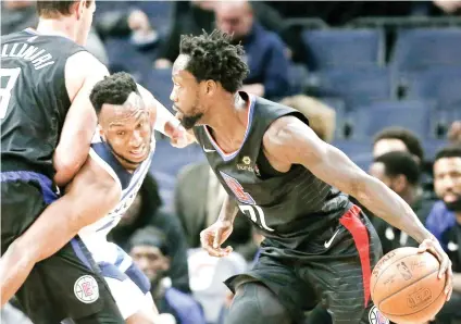  ?? AP FOTO ?? LA IN THE POSTSEASON.Josh Okogie (center) tries to stop Patrick Beverley during their NBA game. The Clippers won to seal their spot in the playoffs after missing out last year.