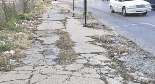  ?? NEIL STEINBERG/SUN-TIMES ?? Some Chicago sidewalks, like this one on Halsted Street in Englewood in 2017, could use some repair.