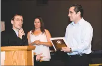  ??  ?? Christophe­r Anderson, left, presents the Arc of Southern Maryland Employer Award to his boss Harold Juarez of MGM Services on Wednesday at the second annual Charles County Job Developers’ Alliance employer award breakfast at New Life Church in La...