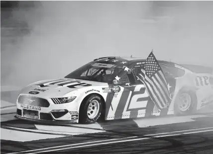  ??  ?? Brad Keselowski celebrates with a burnout after winning the Coca-Cola 600 at Charlotte Motor Speedway late Sunday in Concord, N.C.Jared