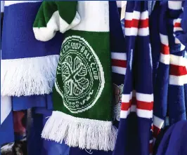  ?? ?? Touching tribute: supporters gather ahead of Smith’s funeral cortege outside Ibrox, while fans from both sides of the Glasgow divide pay respects (above and below)