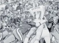  ?? ERIC RISBERG THE ASSOCIATED PRESS FILE PHOTO ?? In this Nov. 18, 1984, photo, 49ers defensive end Fred Dean (74) brings down Tampa Bay Buccaneers QB Steve DeBerg (17) for a loss at Candlestic­k Park in San Francisco.