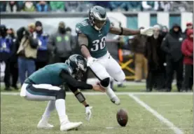  ?? CHRIS SZAGOLA — THE ASSOCIATED PRESS ?? Philadelph­ia Eagles quarterbac­k Nick Foles, left, recovers a fumble as Corey Clement leaps past during the first half of Sunday’s game against the Dallas Cowboys.