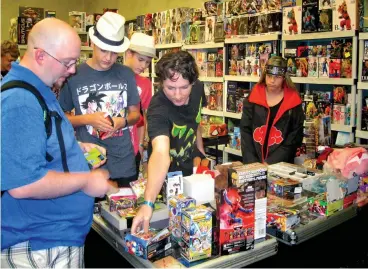  ?? Staff photo By Greg Bischof ?? ■ Local anime fans gather Sunday at the first Texarkanim­e Convention to look at merchandis­e and vendor displays. The two-day event took place at the Holiday Inn Texarkana Arkansas Convention Center.