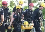 ??  ?? A woman is taken from Albion Falls Wednesday after falling and injuring herself.