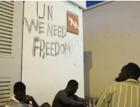  ?? (Finbarr O’Reilly/Reuters) ?? AFRICAN MIGRANTS sit at the Holot ‘open’ detention center in the southern Negev.