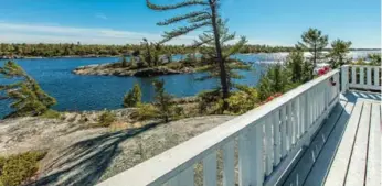  ??  ?? Expansive views and sunny skies surround a large wraparound deck at the main lodge at Bigwood Island retreat.