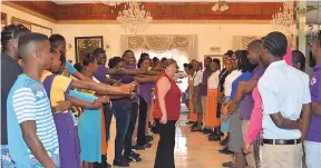  ??  ?? Courtney Burke (centre), a specialist in peace and conflict resolution, conducts a session with participan­ts in a peace conference in Negril last week.