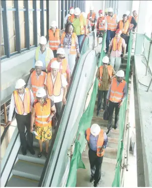  ??  ?? Ministers use the escalator from the air bridge, which takes passengers to the departure terminal. (Terrence Thompson photo)