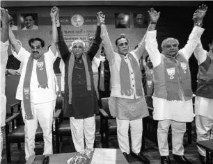  ??  ?? Armed with a diploma in civil engineerin­g, Bhupendra Rajnikant Patel (second from left) is also realtor by profession, which political observers believe might come in handy in raising funds for the party ahead of polls