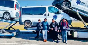  ?? ?? Lucas Wojcik (second from left) led efforts to get desperatel­y needed ambulances to Ukraine