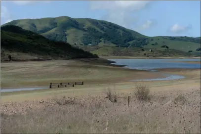  ?? ALAN DEP — MARIN INDEPENDEN­T JOURNAL ?? A bridge is revealed by low water levels at Nicasio Reservoir in Nicasio. Rain levels are at record lows in some areas.