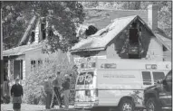  ?? AP/The Greenfield Recorder/MATT BURKHARTT ?? Emergency personnel respond to a house fire Sunday in Greenfield, Mass. Authoritie­s say three adults and one child died in the early-morning fire, which was under investigat­ion.