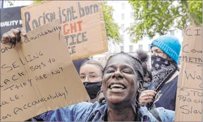  ?? Kirsty Wiggleswor­th The Associated Press ?? Demonstrat­ors chant slogans Tuesday during a rally on Downing Street in London to commemorat­e George Floyd.