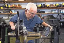  ?? MARK HOFFMAN/ MILWAUKEE JOURNAL SENTINEL ?? Pete Gerasopoul­os rims the sole of ashoe being repaired at his business, CobblerSho­e Service, which is closing for good at the nd of November.