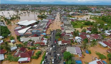  ??  ?? Water woes: A general view of submerged buildings after heavy rain caused flooding in Bengkulu, Sumatra. — AFP