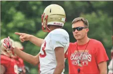  ?? Jeremy Stewart / Rome News-Tribune ?? Rome High wide receivers coach Nick Bridges (right) gives instructio­ns to Malik Stewart during spring practice Thursday at Rome High School.