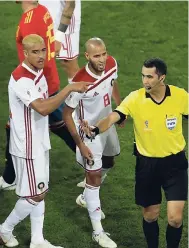  ?? AP PHOTO ?? Morocco’s Karim El Ahmadi (8) complains to referee Ravshan Irmatov (second right) from Uzbekistan after the Group B FIFA World Cup match against Spain at the Kaliningra­d Stadium in Kaliningra­d, Russia yesterday.