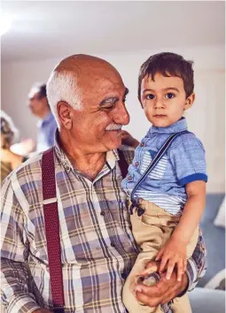  ??  ?? Opposite, from top: Tuba prepares the iftar feast with her mother, Ayse; Guests (from left) Julia Manley, Kathy Egea, John Oldmeadow and Ahmet Burak Alpay. Below: Tuba’s father, Hayrettin with his grandson, Esad Ozturk.