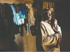  ??  ?? Cocoa farmer Coulibaly Abou, 35, struggles to earn enough for his wife and six children, including his one-year-old son, Sidiki, in an Ivory Coast village.