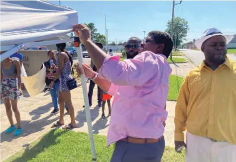  ?? (Pine Bluff Commercial/Byron Tate) ?? Jefferson County Sheriff Lafayette Woods Jr. sets up a tent for family members outside the Dub Brassell Detention Center during a June 16 protest over the handling of inmate Dezmen X. McBride’s death.