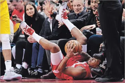  ?? NATHAN DENETTE THE CANADIAN PRESS ?? Raptors guard Kyle Lowry falls out of bounds with the ball against the Indiana Pacers during first-half NBA action in Toronto on Sunday. Lowry finished the night with 12 points, eight assists, three rebounds and three steals in a 121-105 Raptors victory.