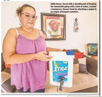  ??  ?? Millie Reyes, faced with a daunting job of keeping her household going with a lack of water, created a temporary shower head by attaching a spigot to an empty detergent container.