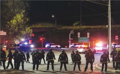  ?? (File Photo/AP/Paula Bronstein) ?? Portland police confront May Day protesters May 1 at the ICE facility in Portland, Ore.