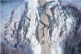  ?? MARC LESTER/ANCHORAGE DAILY NEWS ?? An aerial photo shows damage on a road south of Wasilla, Alaska, after back-to-back earthquake­s measuring 7.0 and 5.7 shattered roads and rocked buildings on Friday.