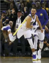  ?? THE ASSOCIATED PRESS ?? Golden State Warriors’ Stephen Curry (30) and Draymond Green celebrate a score against the Denver Nuggets during the second half of an NBA basketball game Monday in Oakland.