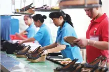  ??  ?? Workers check quality at a shoe factory in China’s southern Guangdong province. (AFP)