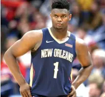  ?? Rusty Costanza/Associated Press ?? ■ New Orleans Pelicans forward Zion Williamson walks onto the court on March 6 during the second half of the team's game against the Miami Heat in New Orleans.