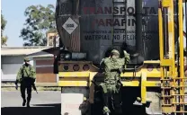  ?? PHOTO: REUTERS ?? Tight security . . . A soldier prepares to check a tanker truck as it arrives at the state oil firm Petroleos Mexicanos (Pemex) refinery in Salamanca, Mexico, yesterday.