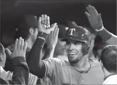  ??  ?? DUGOUT CUSTOMS: Robinson Chirinos receives congratula­tions in the Rangers’ dugout after his two- run homer off David Price as
defeats the host Toronto Blue Jays 5- 3 in the first game of their American League division series Thursday.