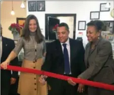  ?? DAVID PORTER — THE ASSOCIATED PRESS ?? Chef Candido Ortiz, center, prepares to cut the ceremonial red ribbon opening his restaurant, El Sabor Del Cafe, Tuesday in Jersey City, N.J. The former prison chef who was serving a 49-year federal sentence for drug-related crimes when he was released...