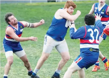  ??  ?? Thorpdale’s Wade Allen fires away a handball; Photograph­s: Paul Cohen.