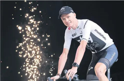  ??  ?? Fireworks go off as four-time Tour de France winner Chris Froome arrives on the podium during the Tour de France team presentati­on in La Roche-surYon, Vendee region, France.