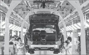  ?? ZHOU LIQIN / FOR CHINA DAILY ?? Workers ready the first batch of Peugeot 4008 automobile­s for delivery at Dongfeng Peugeot Citroen Automobile Ltd’s Chengdu plant in 2016. China will open up its general manufactur­ing sector and also increase access for foreign investors to other...