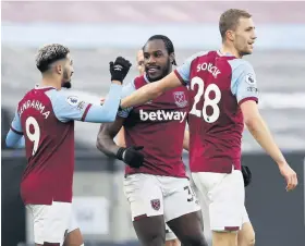  ??  ?? West Ham’s Michail Antonio, centre, celebrates scoring against Burnley