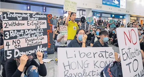  ??  ?? DEMANDS: A young protester shouts during the rally against a controvers­ial extraditio­n bill in the arrivals hall of the busy airport