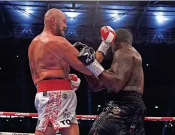  ?? NICK POTTS/PA VIA AP ?? Tyson Fury, left, knocks down Dillian Whyte to win their WBC heavyweigh­t title fight Saturday at Wembley Stadium in London.