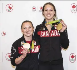  ?? CP PHOTO ?? Canadian Olympic gold medallists Penny Oleksiak, right, and Rosie MacLennan show off their medals at Pearson Airport in Toronto yesterday.