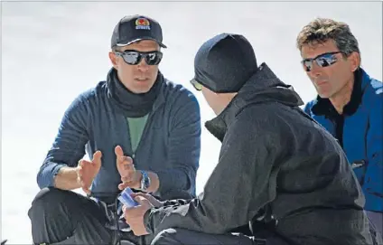  ??  ?? On location: Matthew Metcalfe talks to Chris Payne, centre, and Mladen Ivancic, right, from the New Zealand Film Commission during filming of Beyond the Edge.