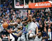  ?? JEFF WHEELER/STAR TRIBUNE VIA AP ?? Minnesota Timberwolv­es guard Jimmy Butler slaps the ball from Denver Nuggets forward Will Barton while defending with Timberwolv­es center Karl-Anthony Towns (32) during Wednesday’s NBA clash in Minneapoli­s.