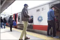  ?? Tyler Sizemore / Hearst Connecticu­t Media ?? Passengers board a Metro-North train bound for Grand Central Terminal at the Stamford Transporta­tion Center in Stamford on April 7. Ridership has been slowly increasing recently but is still down 78 percent from pre-pandemic levels.