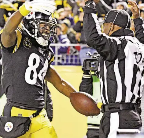  ?? AP ?? Antonio Brown is all smiles celebratin­g one of his two touchdowns Sunday night, as the Steelers’ star wide receiver puts team on his back and makes an incredible sideline catch that sets up winning field goal to down Packers in thriller.